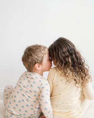 Brother and sister wearing pajamas.