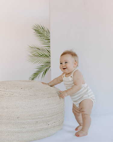 Baby wearing organic cotton stripe knit bubble bubble romper in mushroom stripes with magnetic closures at crotch.  