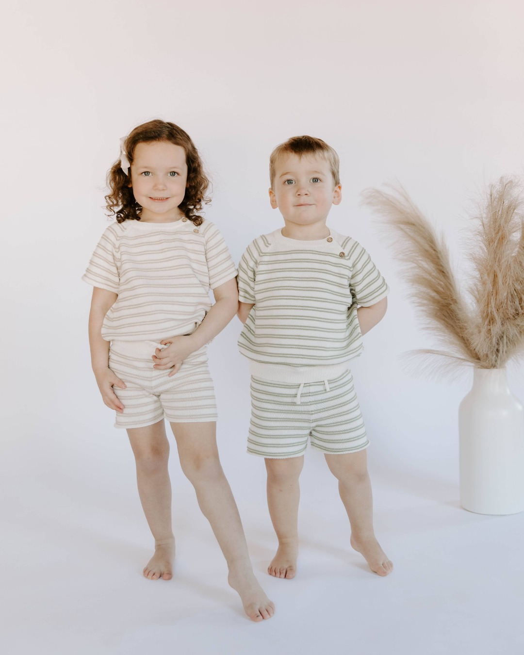 Little boy wearing organic cotton knit stripe short set in sage and little girl wearing the matching mushroom stripe set