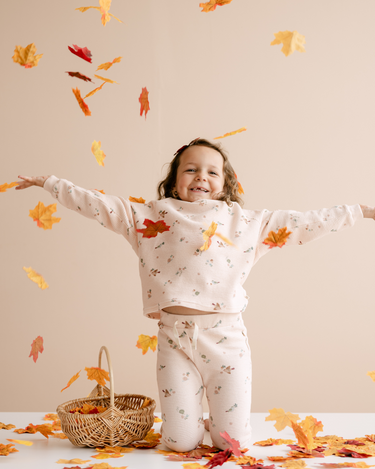 Image shows baby girl wearing organic cotton waffle leggings in bird print.