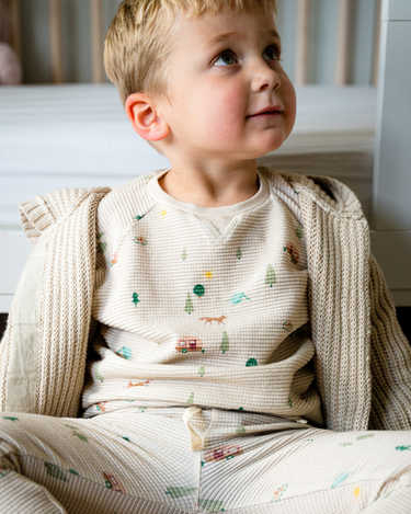Image shows baby boy wearing organic cotton waffle long sleeve tee in camping.