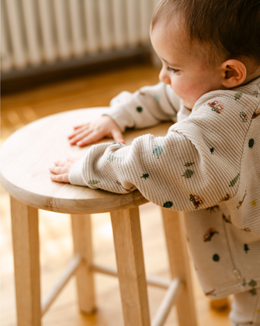 Image shows baby boy wearing organic cotton waffle long sleeve tee in camping.