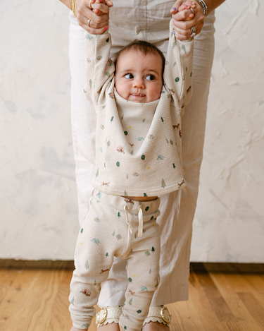Image shows baby boy wearing organic cotton waffle long sleeve tee in camping.