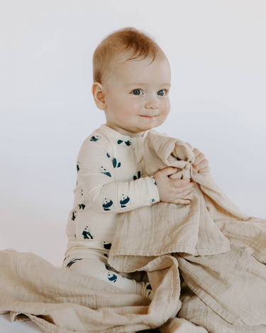 baby boy wearing modal footy pajamas in panda print