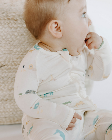 baby girl wearing modal footy pajamas in zoo print