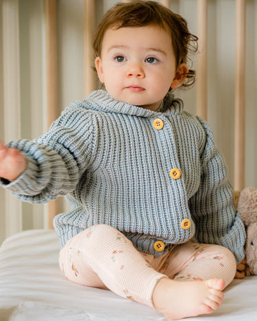 Image shows baby girl wearing pima cotton knit hoody in pearl blue.
