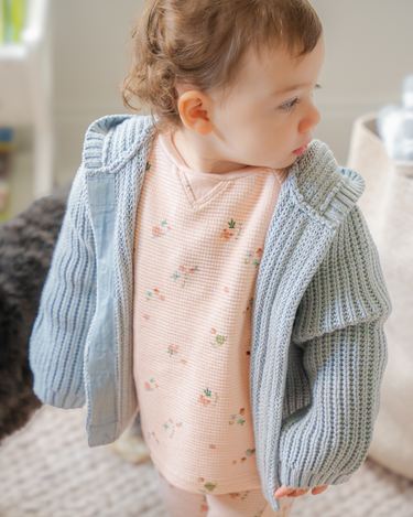 Image shows baby girl wearing pima cotton knit hoody in pearl blue.