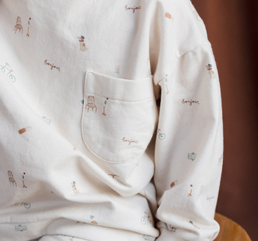 Close up of our organic cotton italian fleece sweatshirt in Paris print with Magnetic Buttons at shoulder.