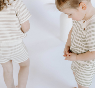Image shows kids wearing organic cotton knit stripe sets with tees and shorts.