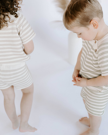 Image shows kids wearing organic cotton knit stripe sets with tees and shorts.
