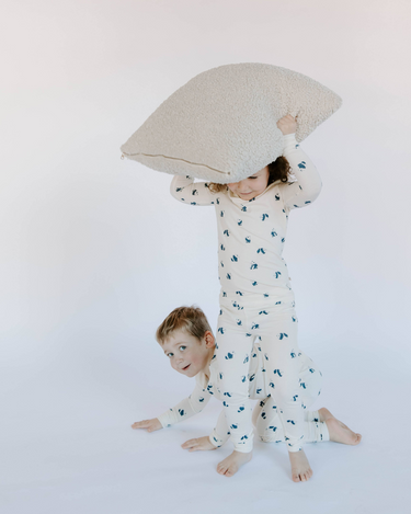 Image shows kids wearing modal pajamas in panda print.