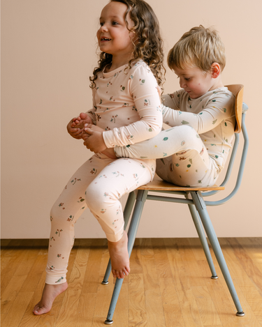 Image shows little girl wearing modal pajama set in birds print.