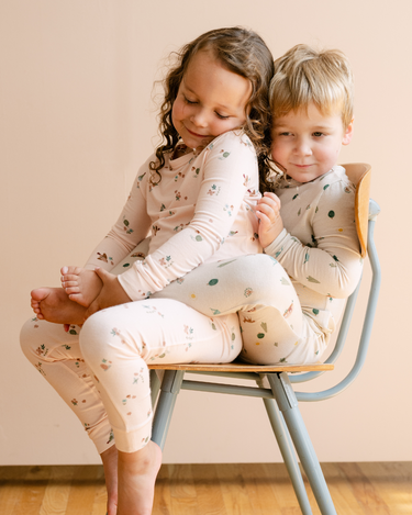 Image shows little girl wearing modal pajama set in birds print.
