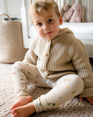 Image shows toddler boy wearing pima cotton knit waffle hoody in oatmeal.