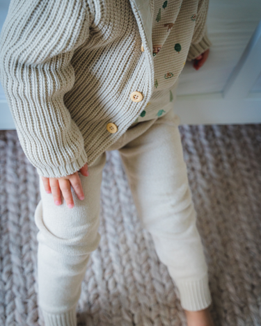 Image shows toddler boy wearing pima cotton knit waffle hoody in oatmeal.