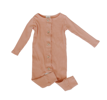 Flat lay image of organic cotton rib playsuit in strawberries and cream color that opens with Magnetic Buttons for easy and struggle-free changing.