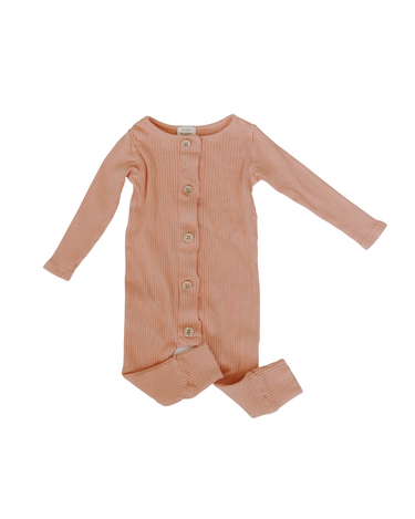 Flat lay image of organic cotton rib playsuit in strawberries and cream color that opens with Magnetic Buttons for easy and struggle-free changing.