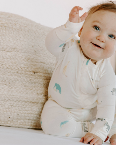 Baby wearing modal zoo print footy pajamas