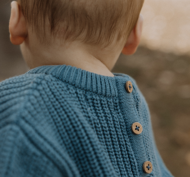baby boy wearing organic cotton chunky knit set in blue stone dear hayden