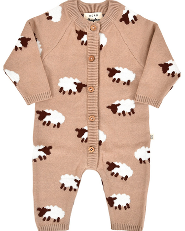 flat lay image of organic cotton beige romper with sheep jacquard pattern and magnetic buttons from neck to crotch