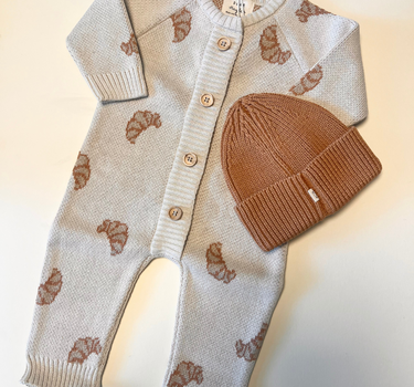Image shows bundle with organic cotton knit croissant romper and organic cotton knit beanie in acorn.