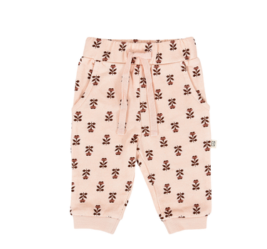 flat lay image of organic cotton fleece joggers in light pink with rose floral pattern for babies and kids