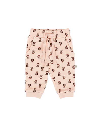 flat lay image of organic cotton fleece joggers in light pink with rose floral pattern for babies and kids