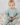 Image shows little boy sitting wearing Organic Cotton Italian fleece joggers in jade color. 