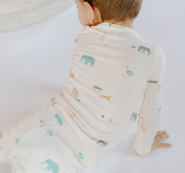 Little boy wearing modal toddler pajama set in zoo print