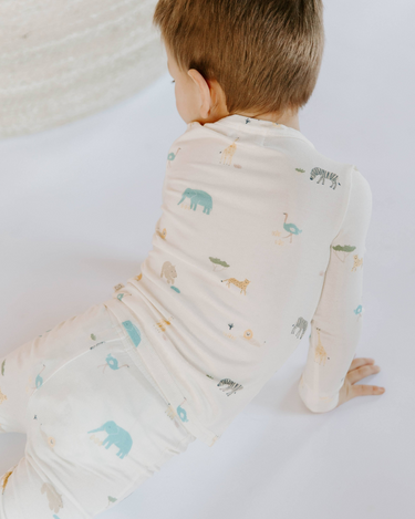 Little boy wearing modal toddler pajama set in zoo print