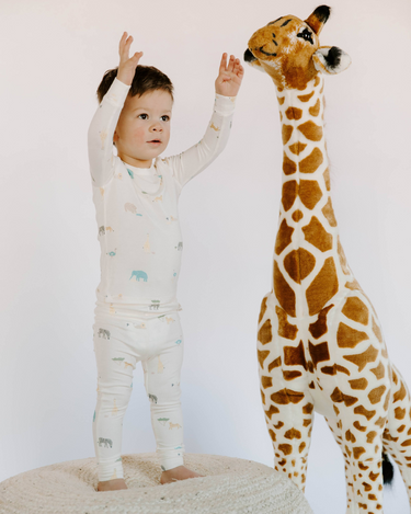 Little boy wearing modal toddler pajama set in zoo print