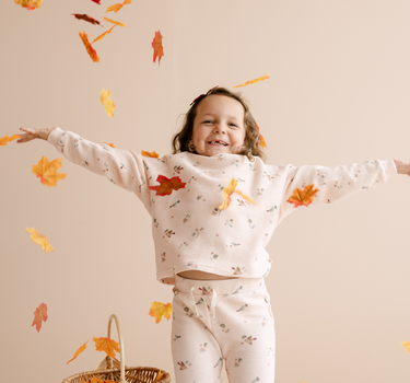 Image shows baby girl wearing organic cotton waffle leggings in bird print. 