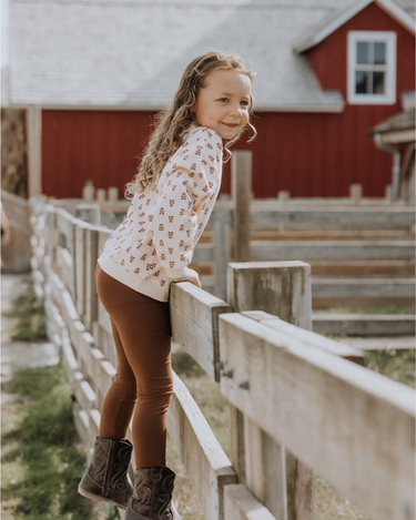 Little girl wearing organic cotton modal leggings in cappuccino. 