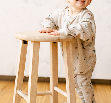 Image shows baby boy wearing organic cotton waffle leggings in camping print.