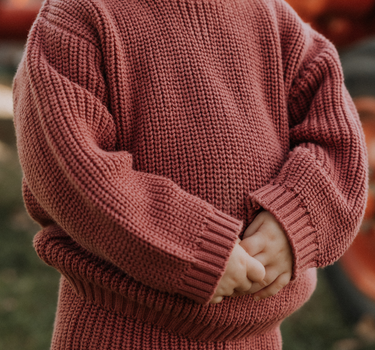 image of toddler girl wearing Dear Hayden organic cotton chunky knit set in rosewood pink