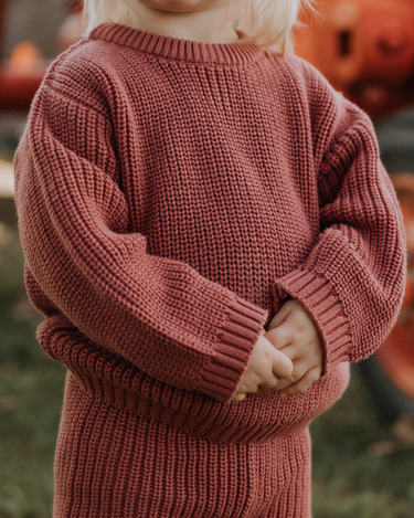 image of toddler girl wearing Dear Hayden organic cotton chunky knit set in rosewood pink