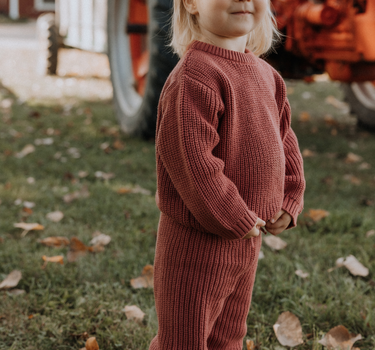 image of toddler girl wearing Dear Hayden organic cotton chunky knit set in rosewood pink