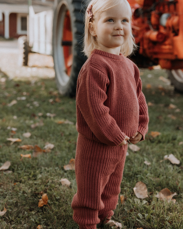 image of toddler girl wearing Dear Hayden organic cotton chunky knit set in rosewood pink