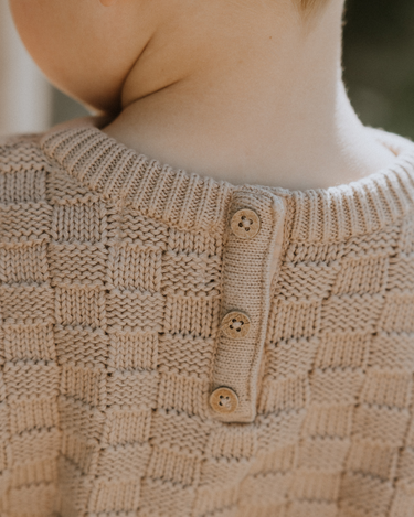 image of little boy wearing Dear Hayden organic cotton basket weave sweater in taupe