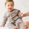 image shows baby boy wearing merino wool baby cardigan in heather brown