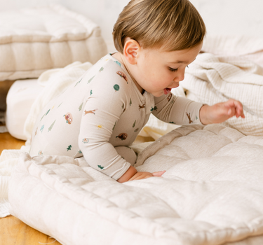 image shows  baby boy wearing modal convertible footy pajamas in camping print