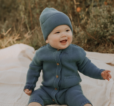 baby boy wearing organic cotton knit beanie in bluestone color