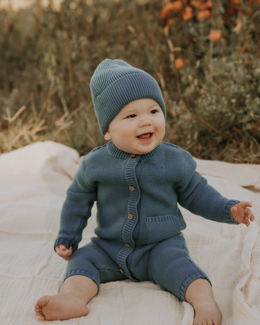baby boy wearing organic cotton knit beanie in bluestone color