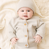 Image shows baby girl wearing merino wool baby gift set in light heather gray. 
