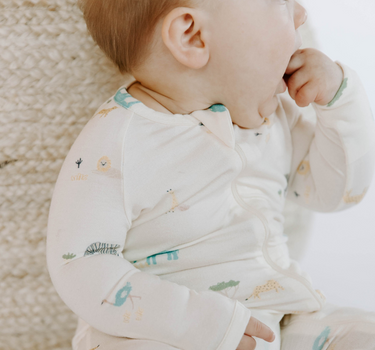 baby girl wearing modal footy pajamas in zoo print
