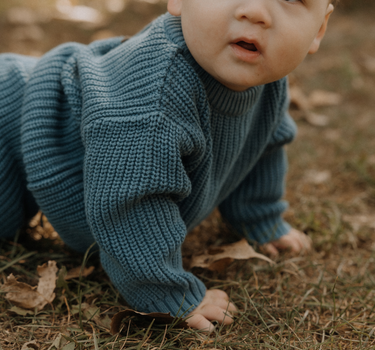 baby boy wearing organic cotton chunky knit set in blue stone dear hayden