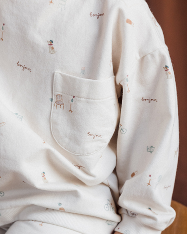 Close up of our organic cotton italian fleece sweatshirt in Paris print with Magnetic Buttons at shoulder.
