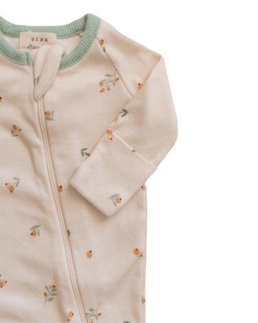 Photo shows close up of organic cotton modal rib footy pajamas in floral bud print.