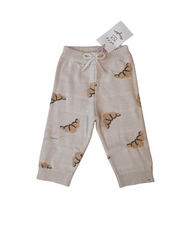 Flat lay image on white of organic cotton knit croissant patterned joggers.