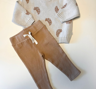 Image shows bundle containing organic cotton knit croissant sweater with organic cotton modal rib leggings in acorn.  